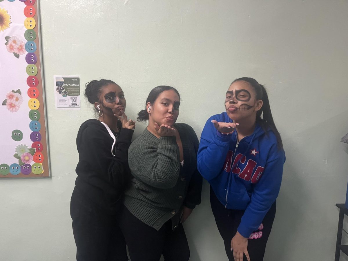 Kasumi Fernandez (10th grade) and Emmaly Fabian and Nayeli Torres (both 9th grade) in their skull face costumes